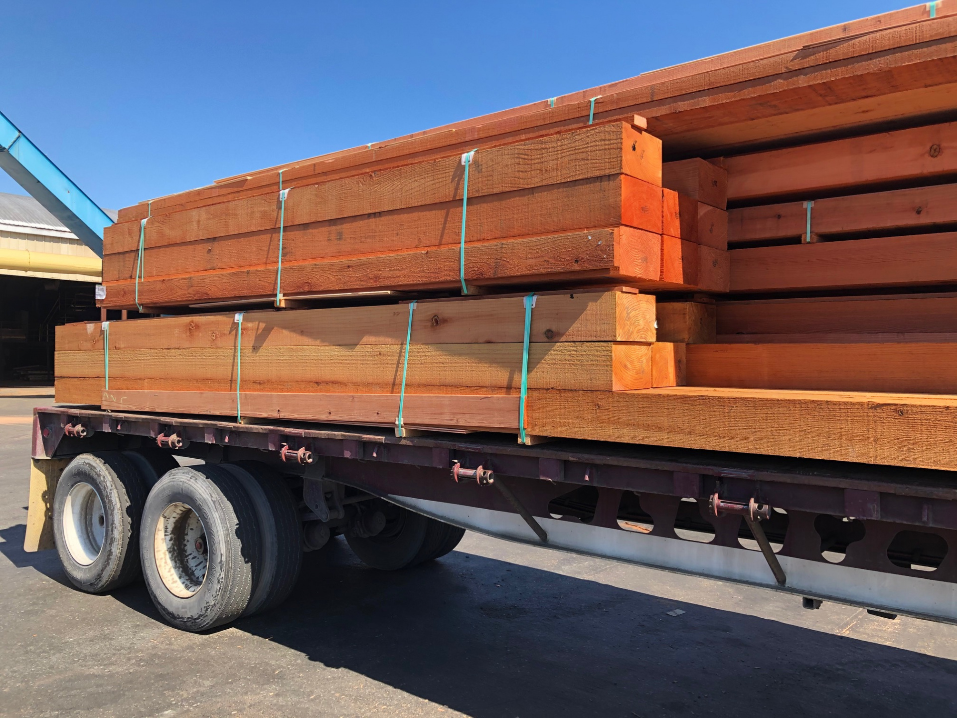 REDWOOD LUMBER stacked on truck